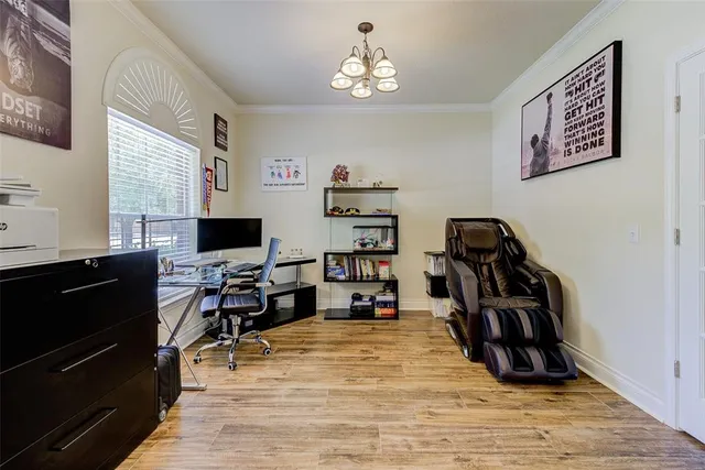 a view of a workspace with furniture and a window