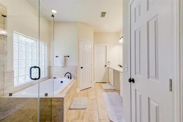 a bathroom with a shower sink and mirror