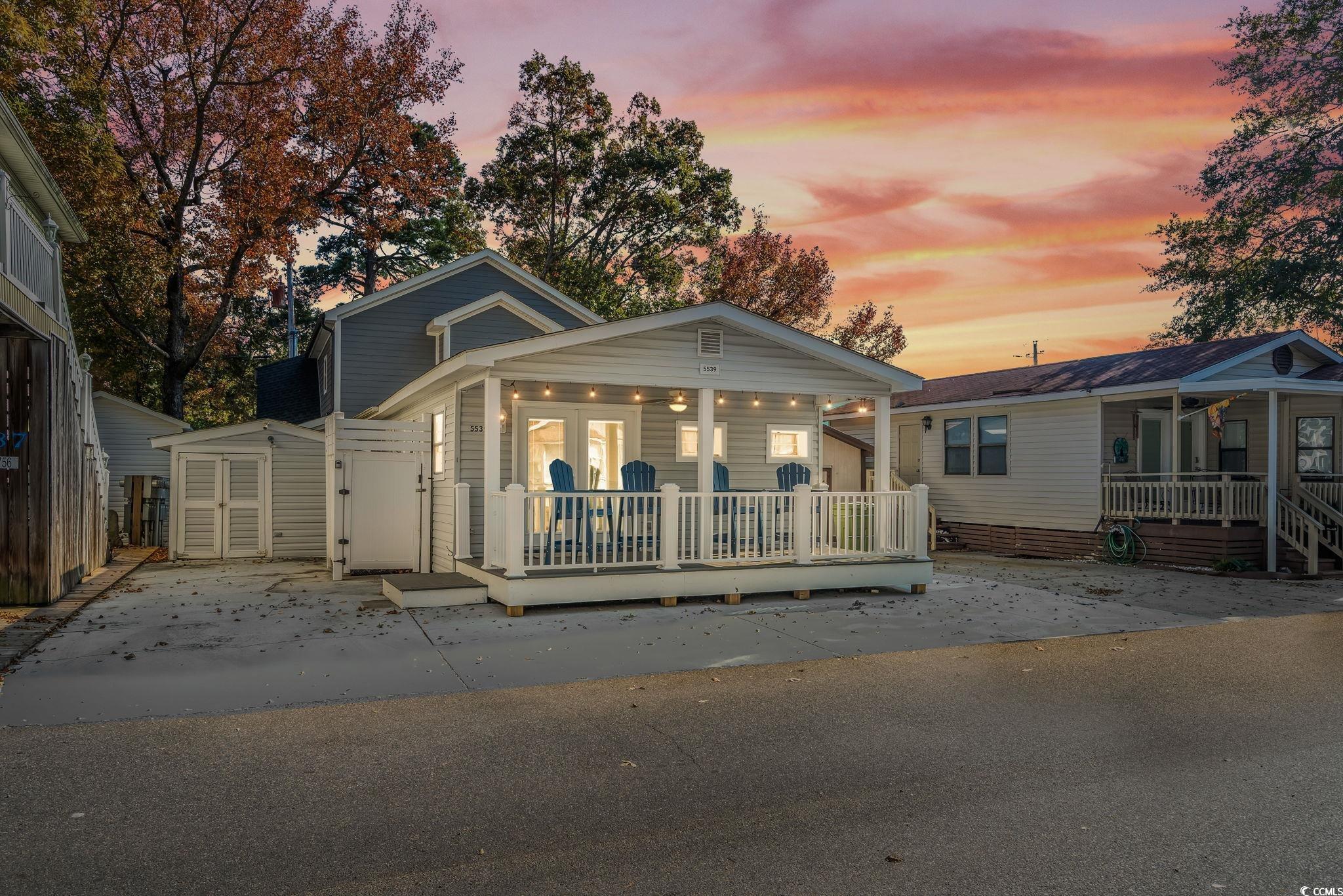 Bungalow-style home featuring a storage shed