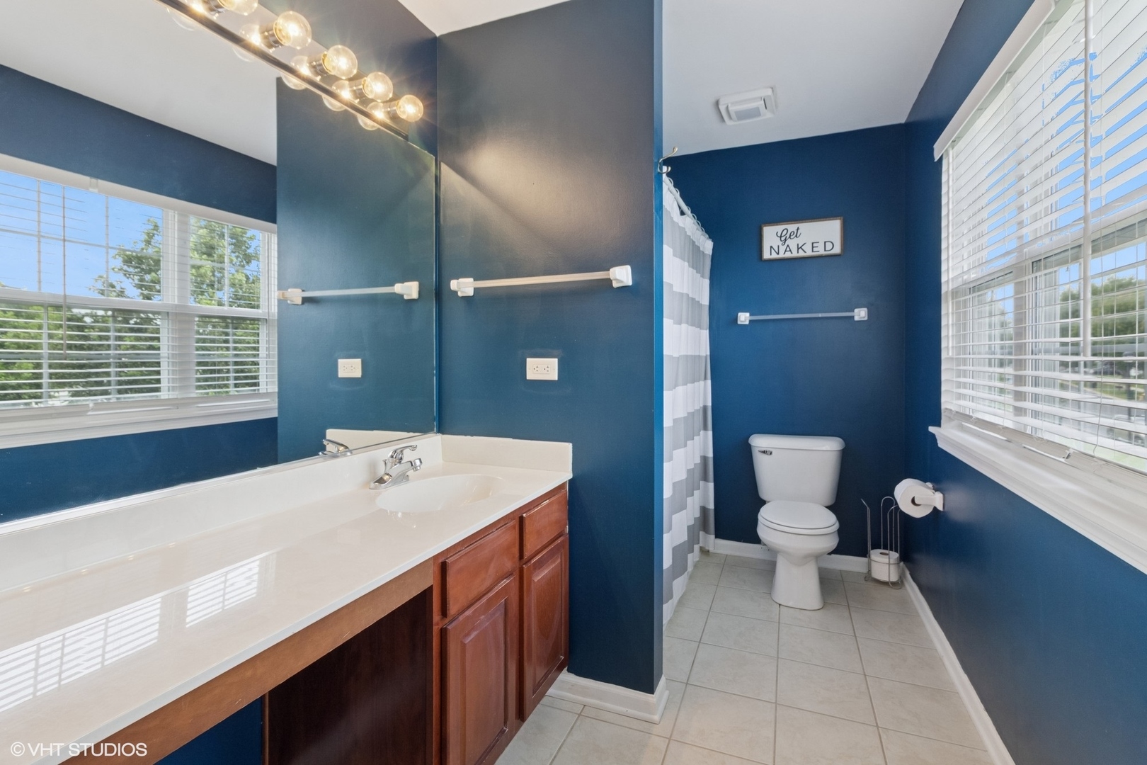 4300 Dobbins Street Plano, IL 60545 - Photo 18 of 31 a bathroom with a sink a toilet and a large mirror
