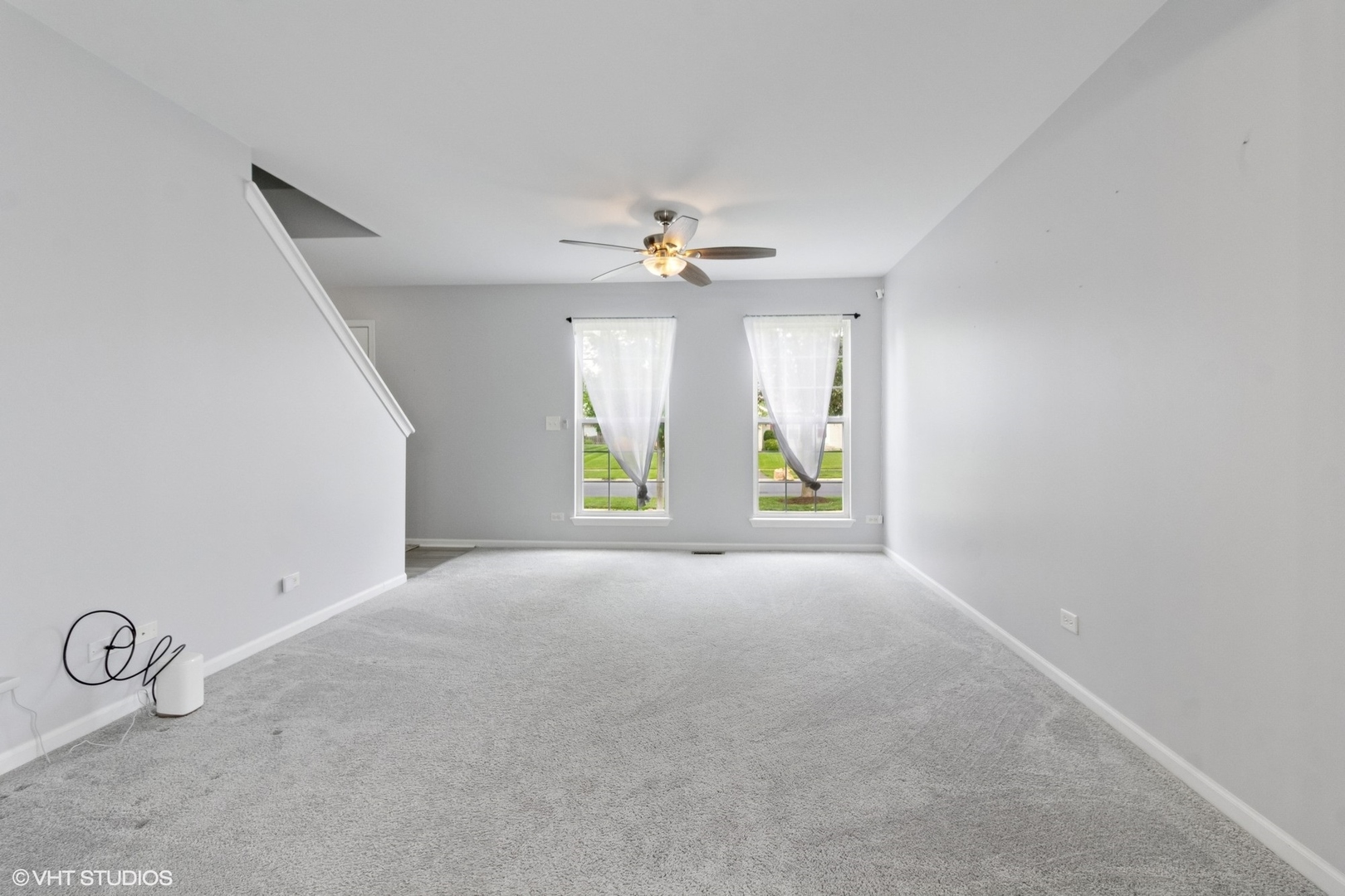 4300 Dobbins Street Plano, IL 60545 - Photo 2 of 31 an empty room with windows and chandelier fan