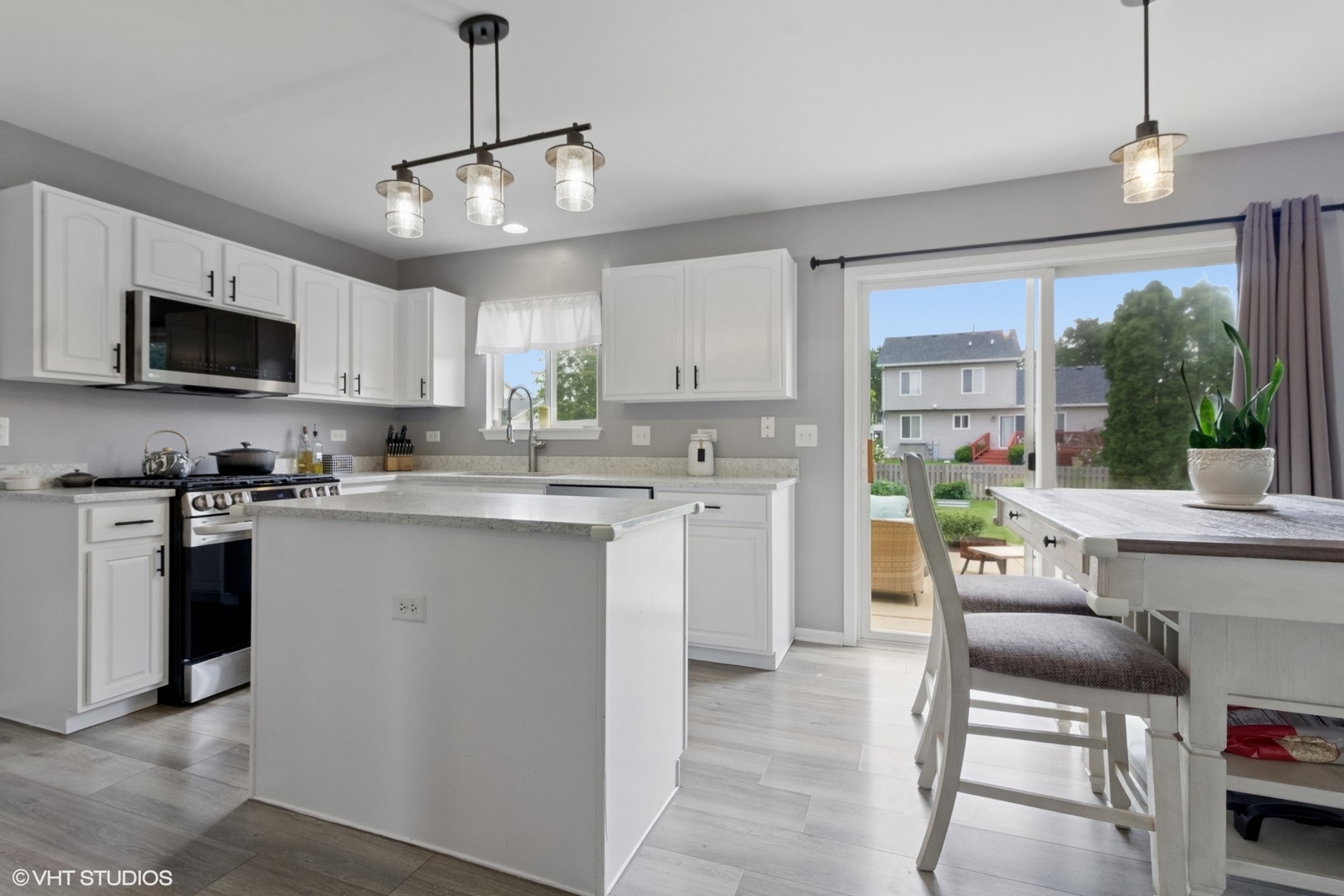 4300 Dobbins Street Plano, IL 60545 - Photo 5 of 31 a kitchen with stainless steel appliances granite countertop a stove top oven a sink a stove a dining table and chairs