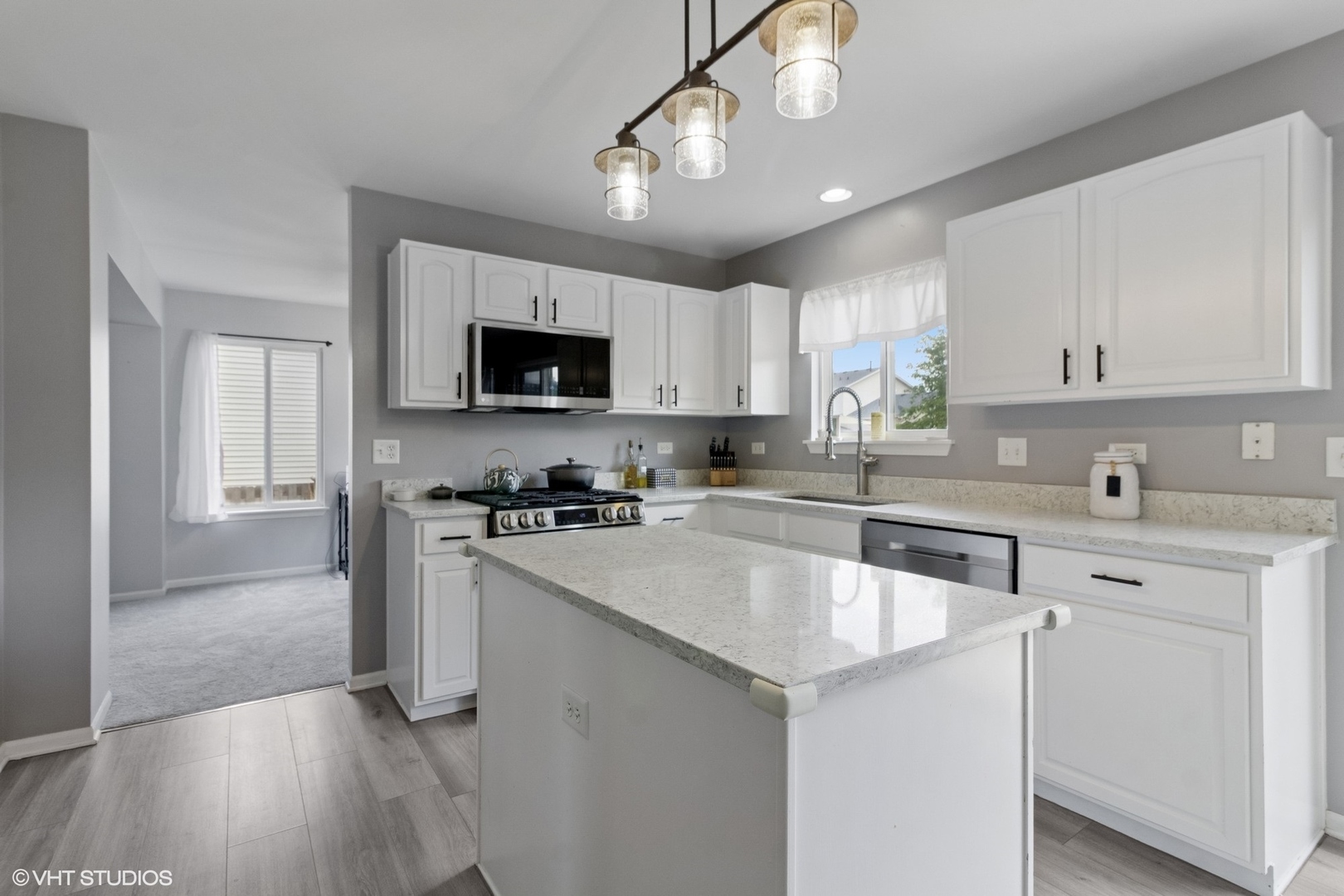 4300 Dobbins Street Plano, IL 60545 - Photo 6 of 31 a kitchen with granite countertop a stove sink and microwave