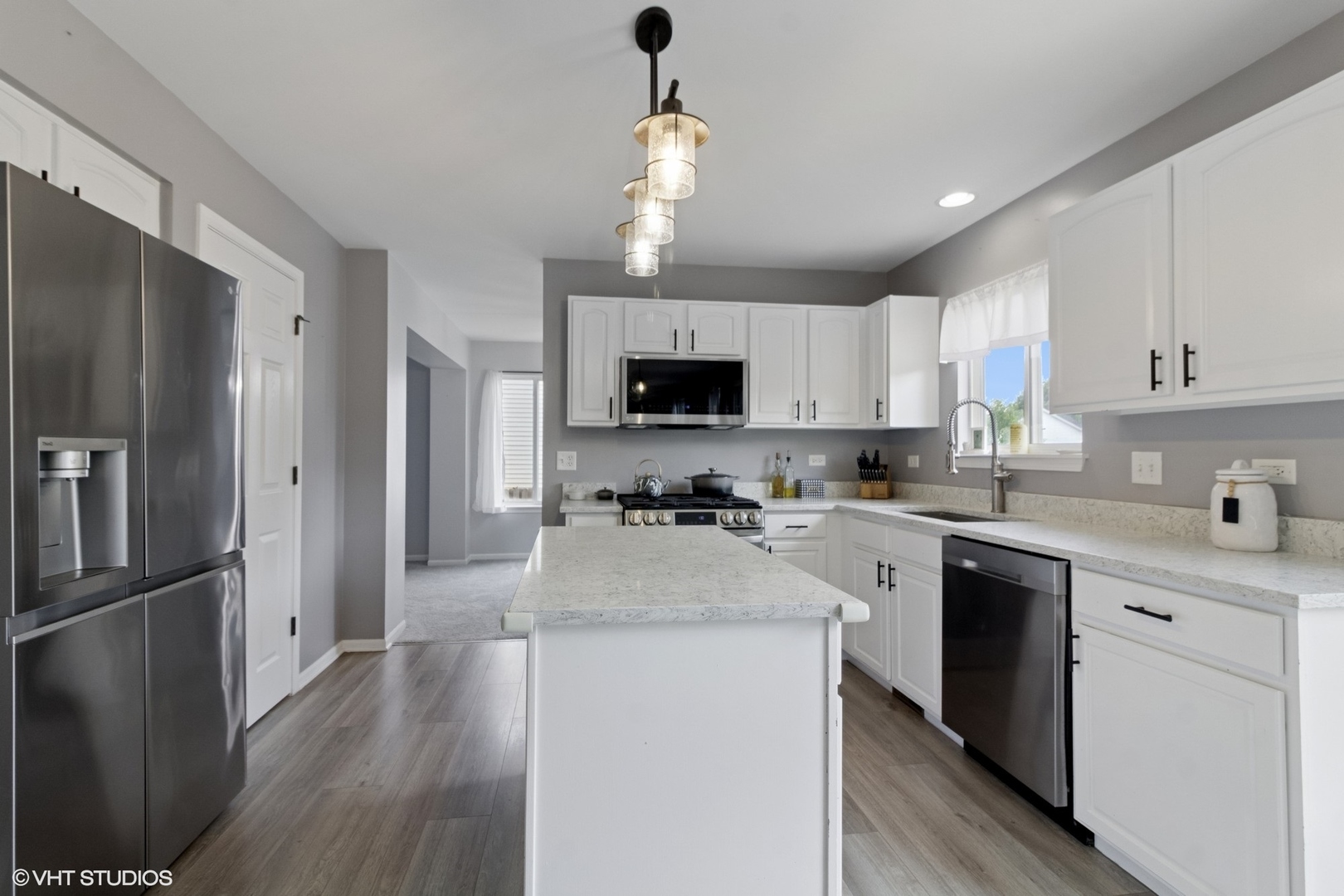 4300 Dobbins Street Plano, IL 60545 - Photo 7 of 31 a kitchen with a refrigerator a sink a stove a microwave and cabinets