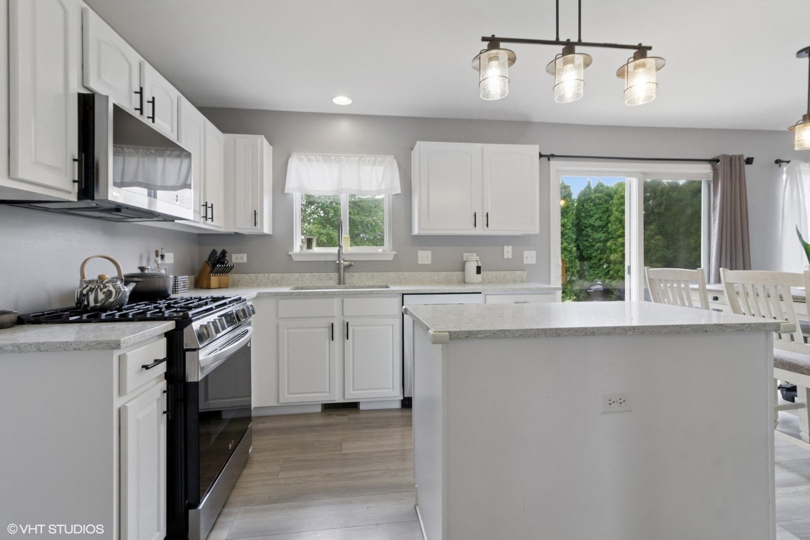 4300 Dobbins Street Plano, IL 60545 - Photo 8 of 31 a kitchen with stainless steel appliances granite countertop a sink a stove and a refrigerator