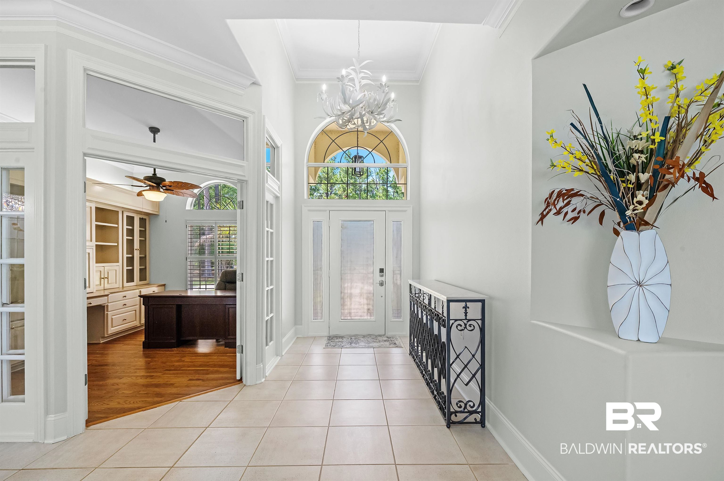8160 Bay View Drive Foley, AL 36535 - Photo 10 of 43 Entrance foyer featuring ornamental molding, a chandelier, light tile patterned flooring, and baseboards