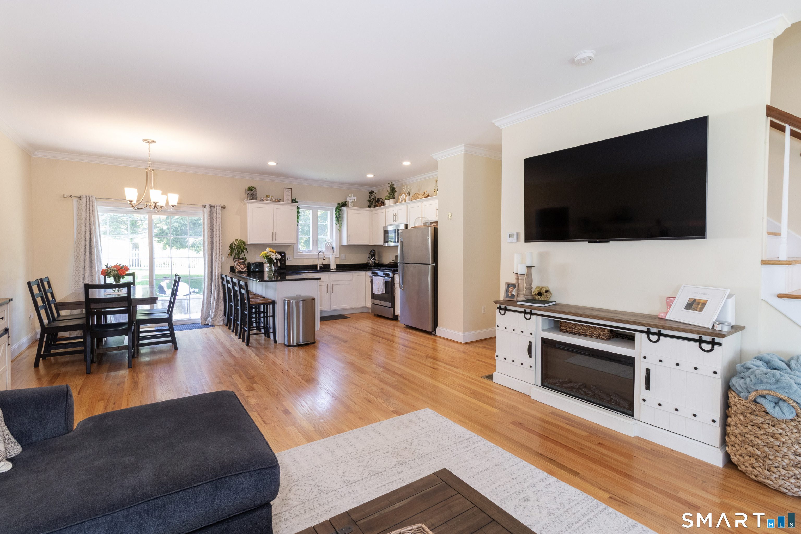 656 Bartholomew Road, Unit 656 Middletown, CT 06457 - Photo 10 of 27 a living room with stainless steel appliances furniture and a flat screen tv