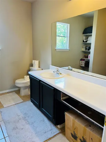 a room with a wooden floor and a toilet