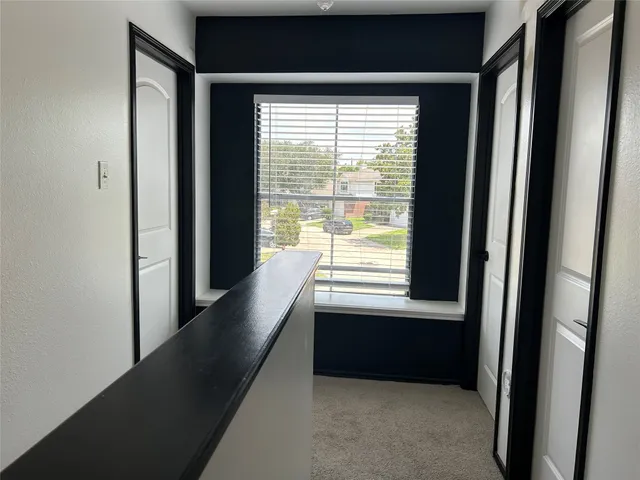 a view of an empty room and a window