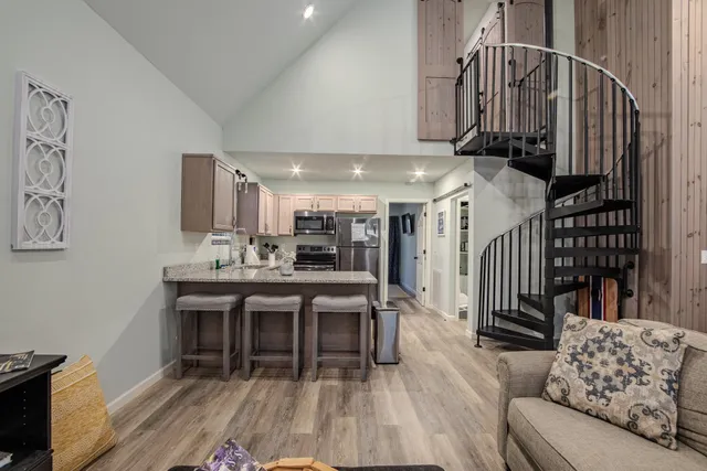 a dining room with furniture entryway and wooden floor
