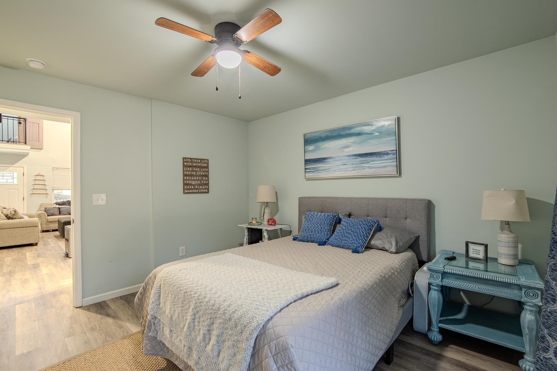 25 Bogey Loop Counce, TN 38326 - Photo 20 of 37 a bedroom with a large bed and a chandelier