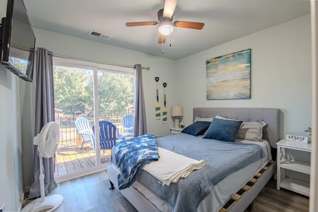 a bedroom with a bed and a large window