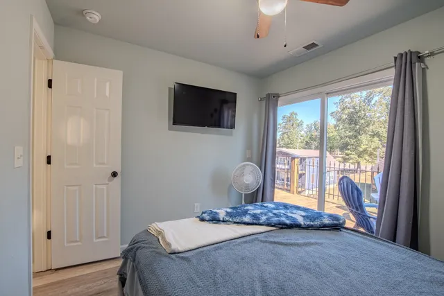 a bedroom with a bed and a flat screen tv