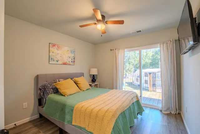 a bedroom with a large bed and a large window