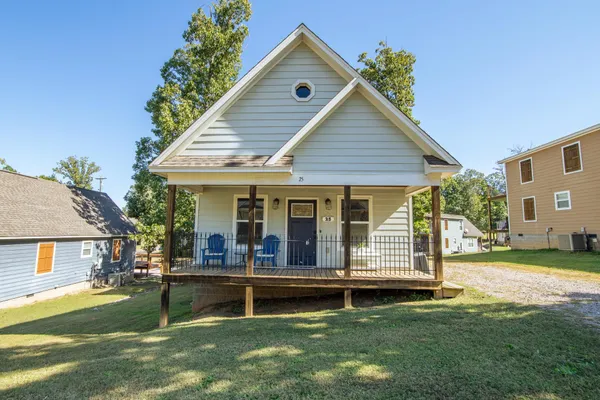a view of a house with a yard porch and sitting area