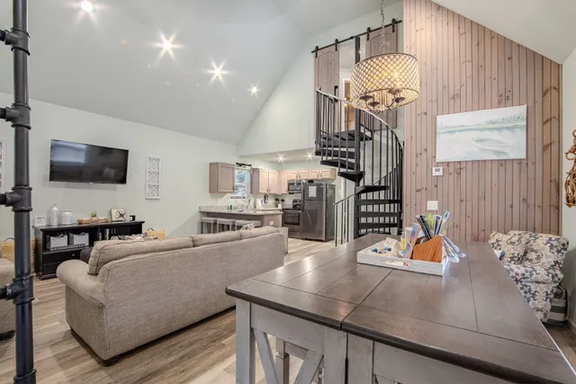 a living room with furniture and a chandelier