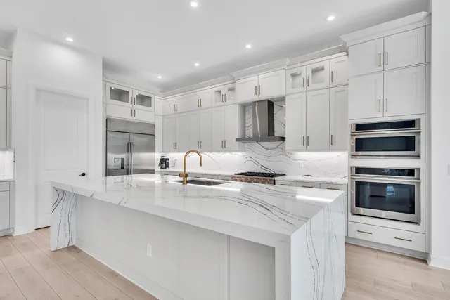 a kitchen with stainless steel appliances granite countertop a sink and cabinets
