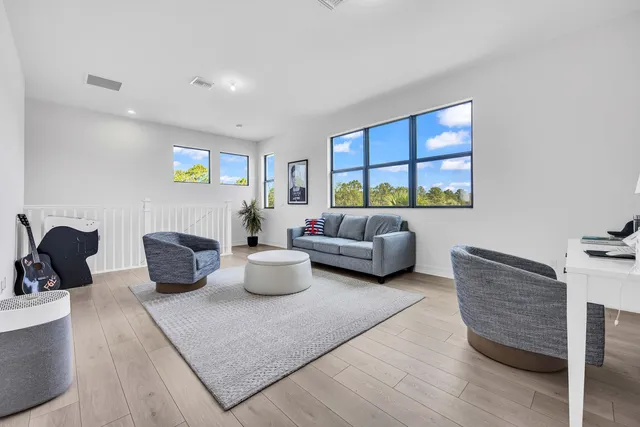 a living room with furniture a rug and a window