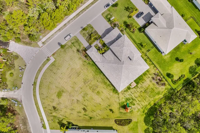 view of a swimming pool with outdoor seating and garden