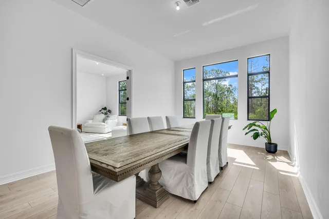 a view of a dining room with furniture and wooden floor
