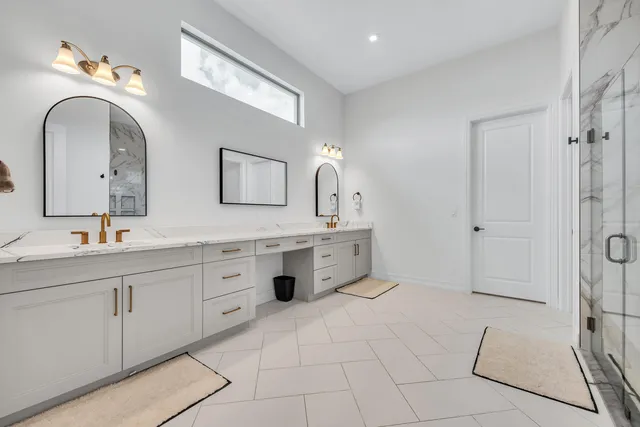 a spacious bathroom with a double vanity sink mirror and