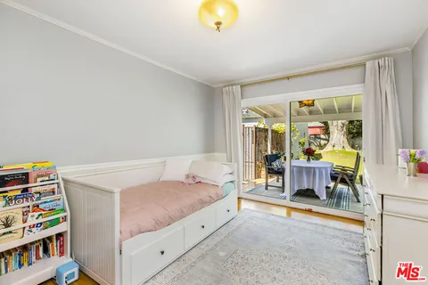 a bedroom with furniture and a book shelf