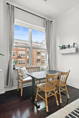 a living room with furniture and a kitchen view