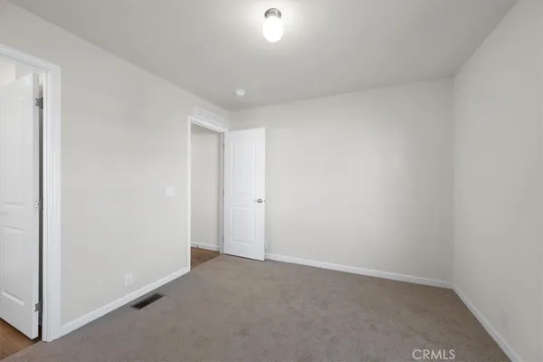 a bathroom with a toilet and a window