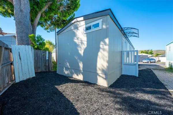 a view of a backyard with wooden fence
