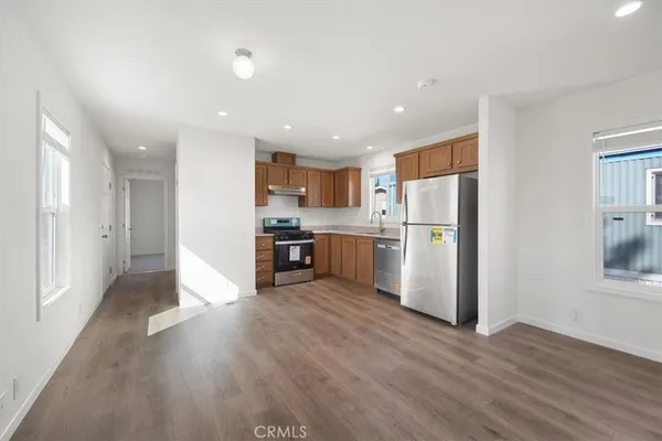 a kitchen with refrigerator a stove a microwave and cabinets