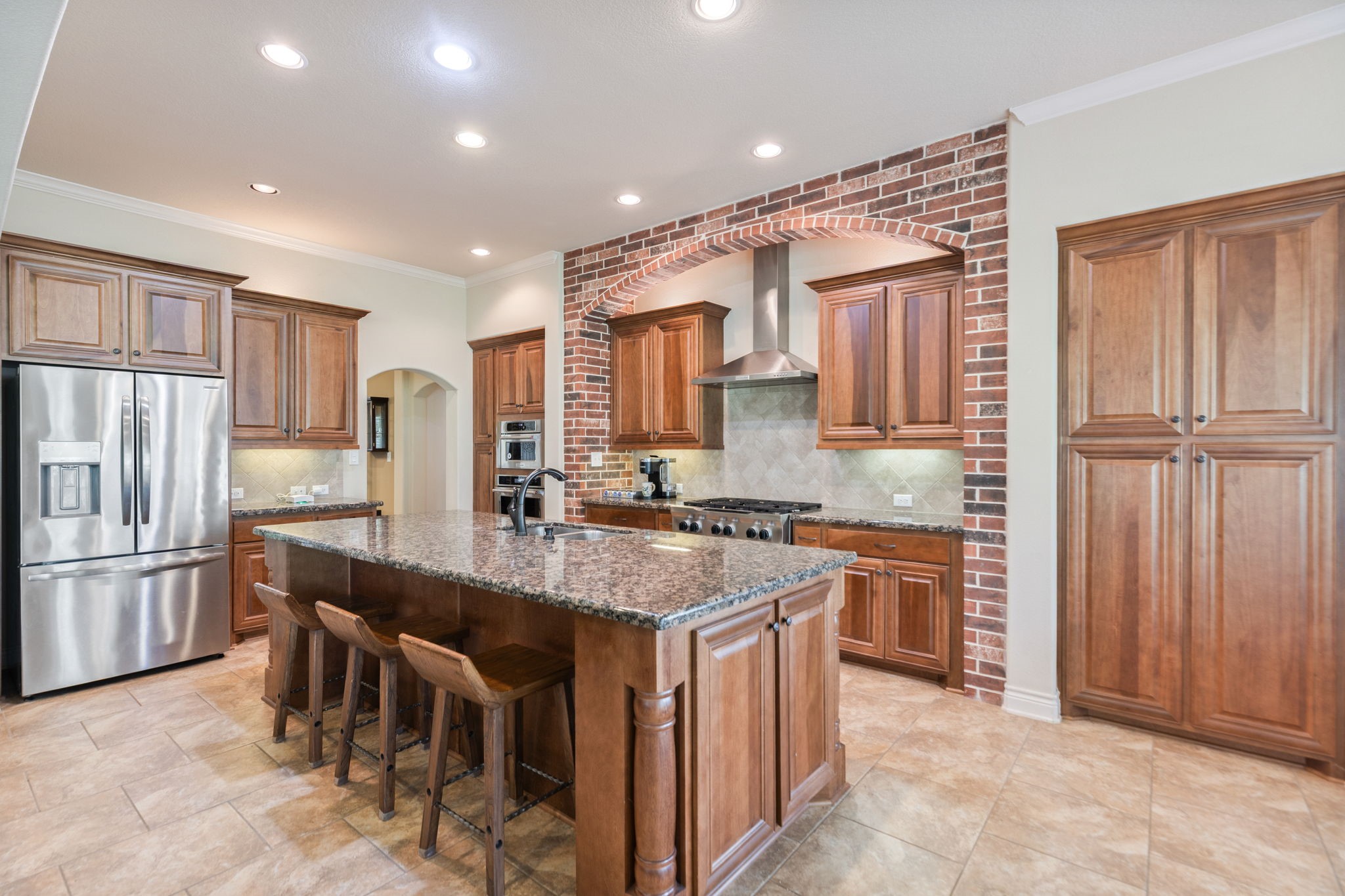 101 Pin Oak Lane Hempstead, TX 77445 - Photo 17 of 50 a kitchen with stainless steel appliances granite countertop a stove top oven a granite counter tops and a refrigerator