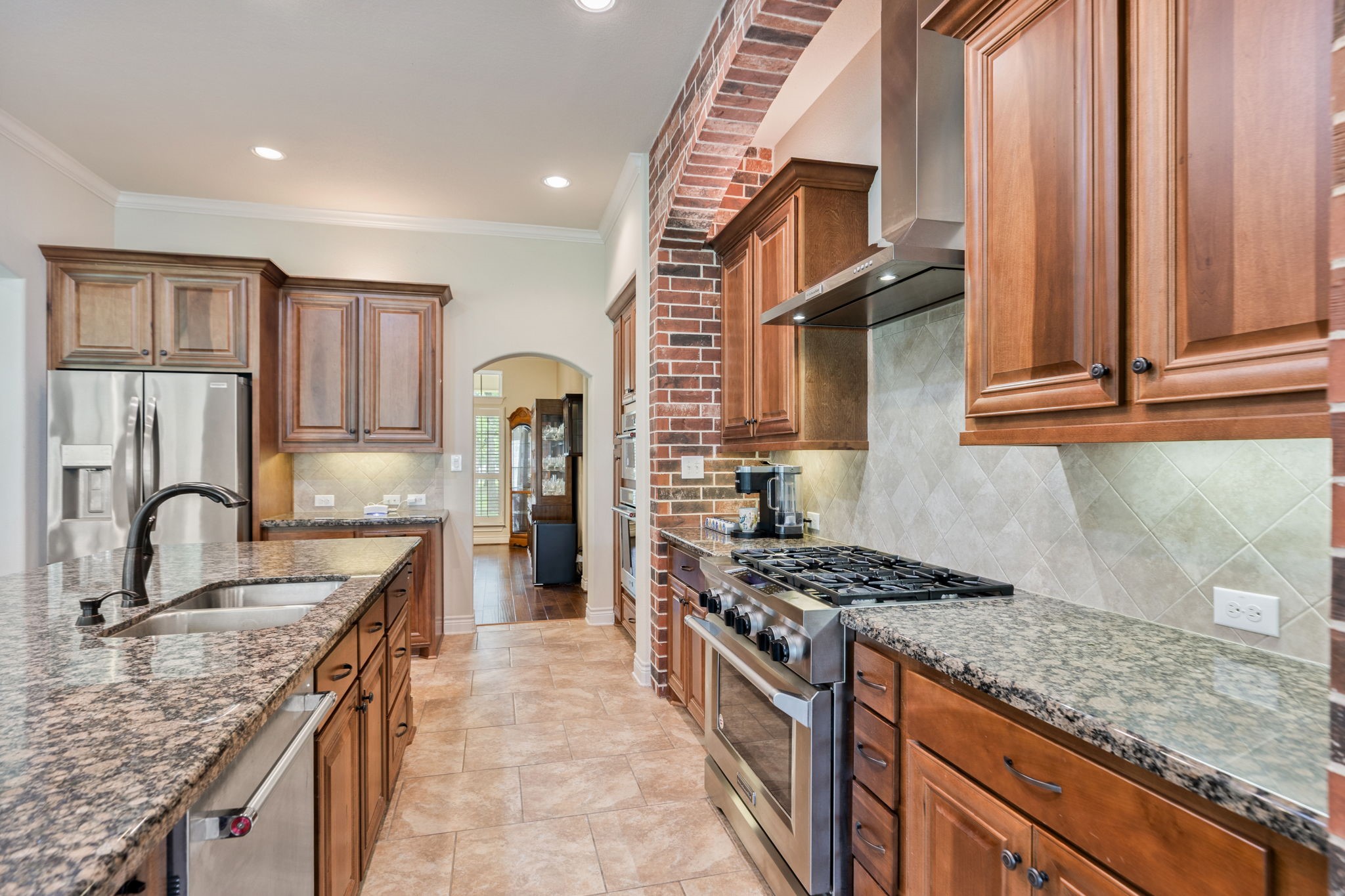 101 Pin Oak Lane Hempstead, TX 77445 - Photo 18 of 50 a kitchen with stainless steel appliances granite countertop a stove a sink and a microwave