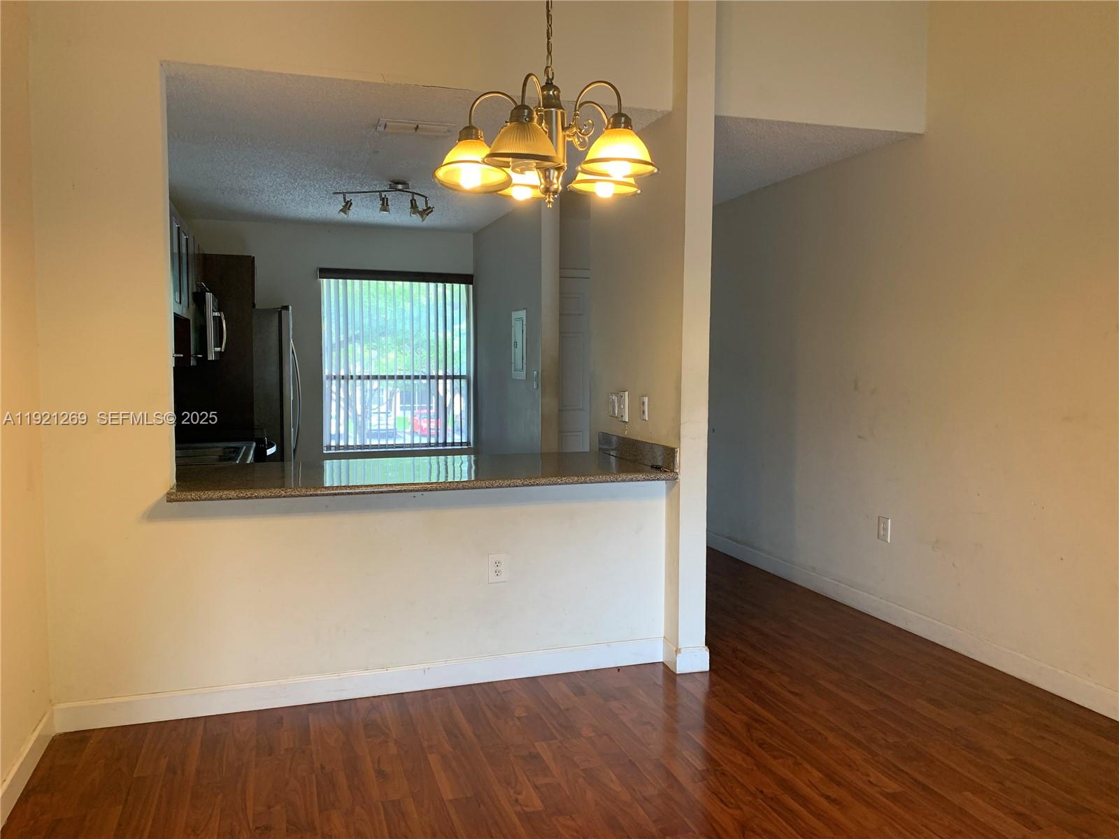 2171 Southwest 80th Terrace, Unit 2171 Miramar, FL 33025 - Photo 3 of 7 an empty room with wooden floor and windows
