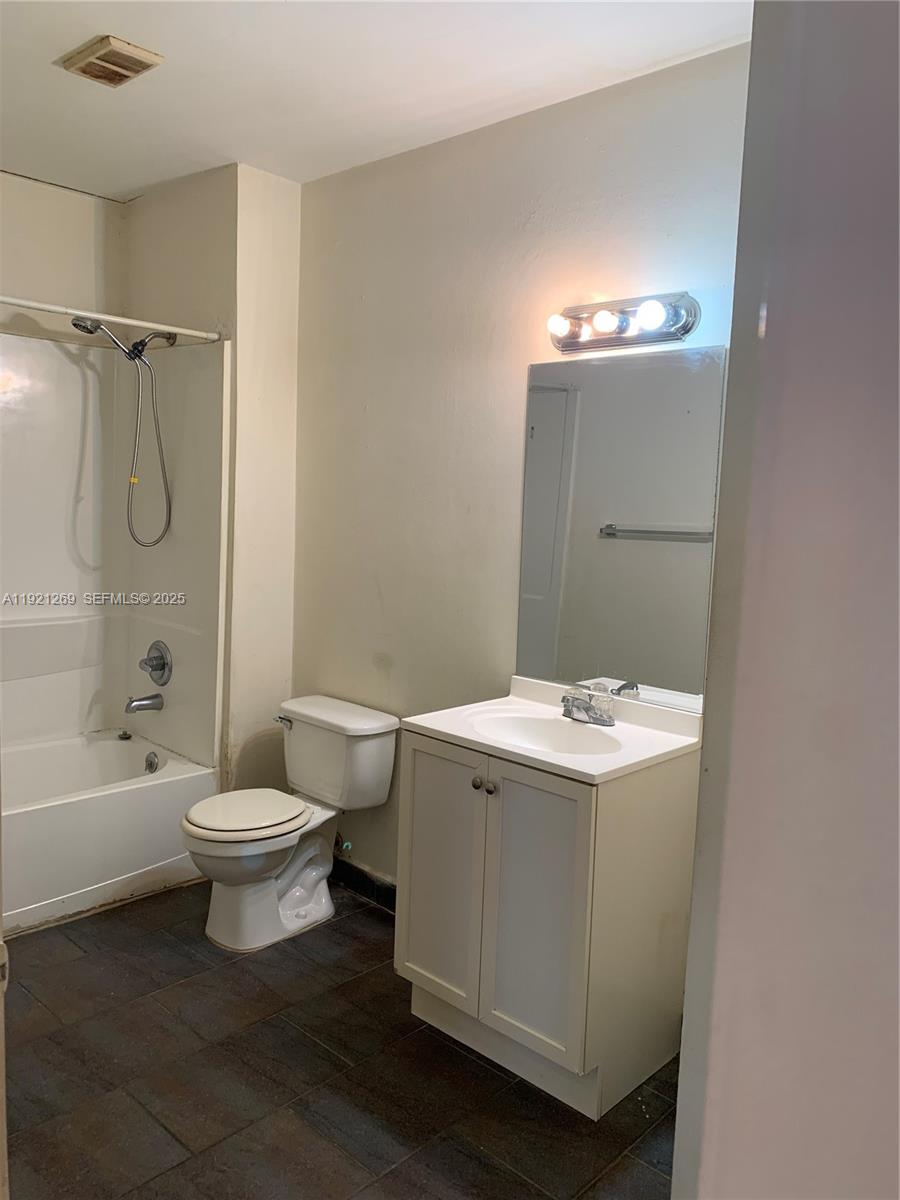 2171 Southwest 80th Terrace, Unit 2171 Miramar, FL 33025 - Photo 5 of 7 a bathroom with a sink a toilet and shower