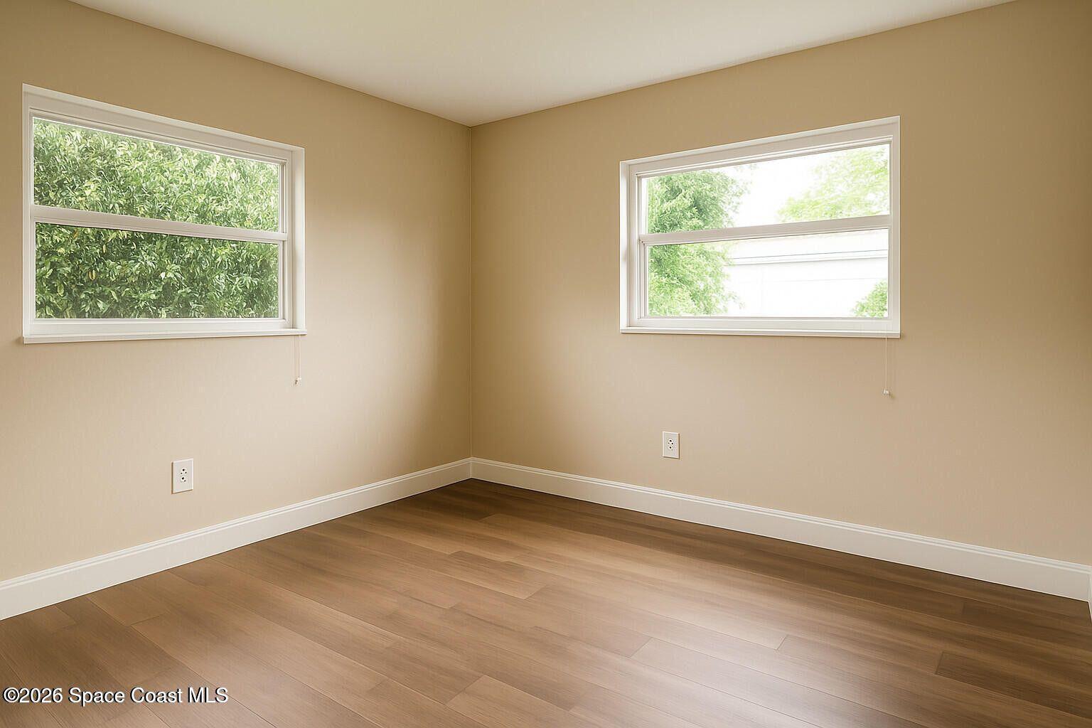 3612 Brophy Boulevard Cocoa, FL 32926 - Photo 11 of 15 an empty room with wooden floor and a window