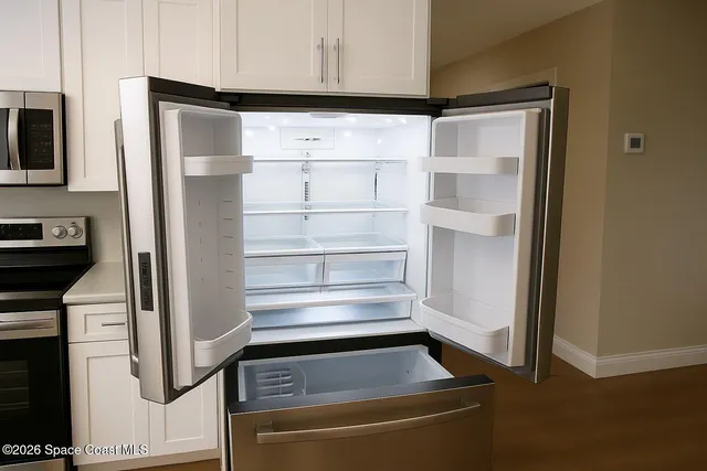 a refrigerator freezer sitting inside of a kitchen