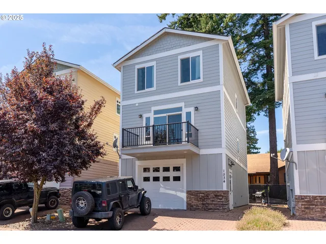 a front view of a house with glass windows and garage