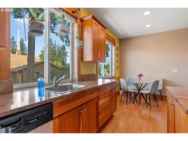 a kitchen with a large window and dining table