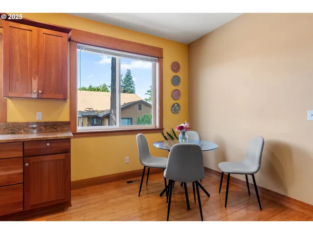 a view of a dining room with furniture and a window