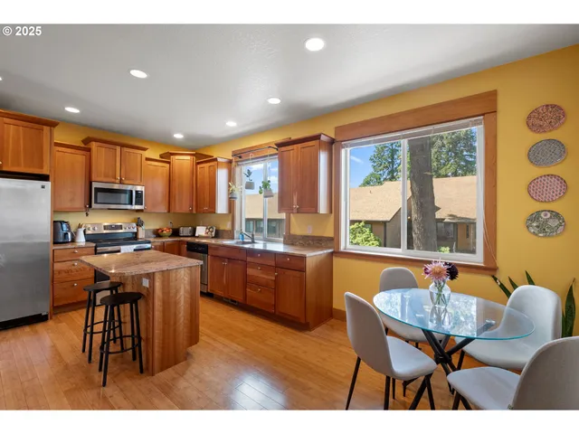 a large kitchen with a table and chairs