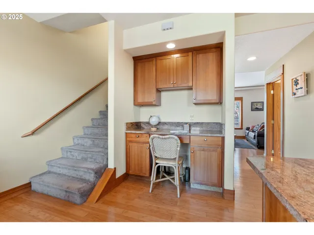 a kitchen with furniture and a wooden floor