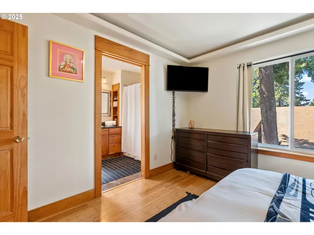 a room with a bed and a television