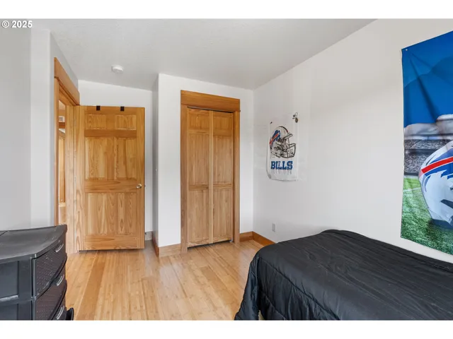 a room with a bed and wooden floor