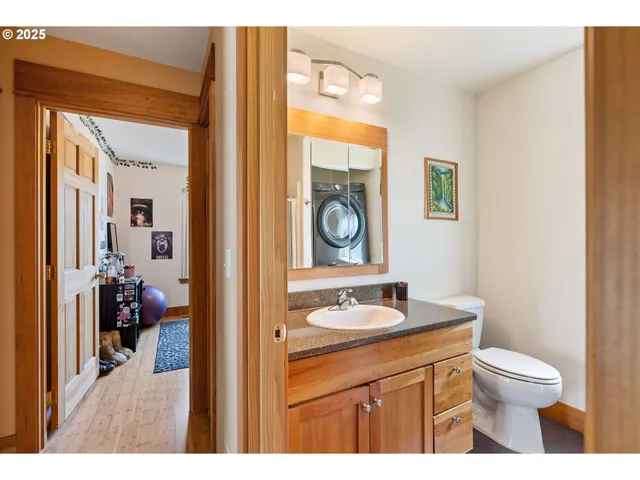 a bathroom with a toilet a sink and a mirror