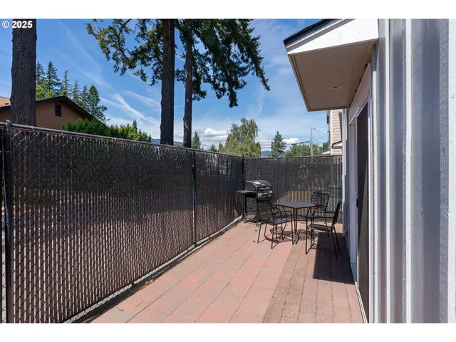 a balcony with table and chairs