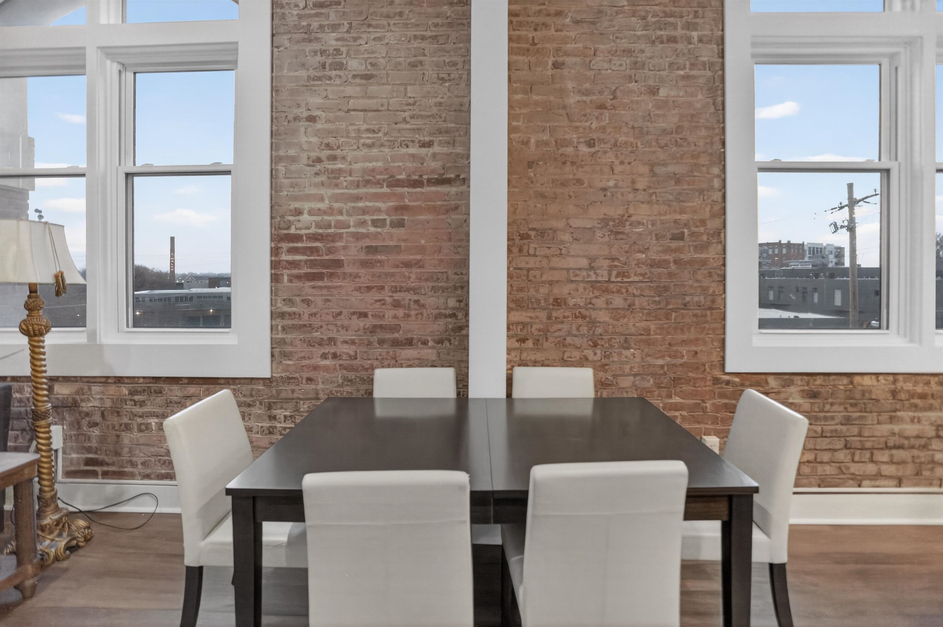 435 South Front Street, Unit 307 Memphis, TN 38103 - Photo 9 of 40 Dining area with wood finished floors and brick wall