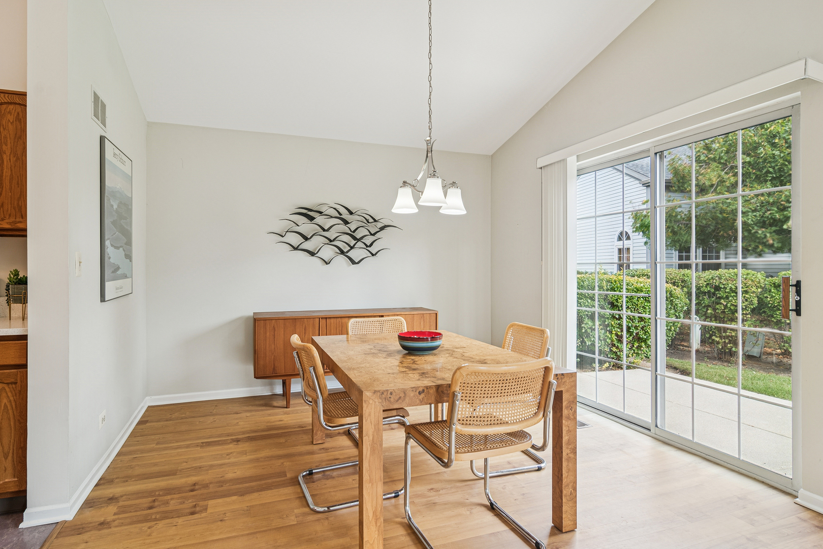 381 Bentley Place Buffalo Grove, IL 60089 - Photo 6 of 22 a dining room with furniture a chandelier and wooden floor