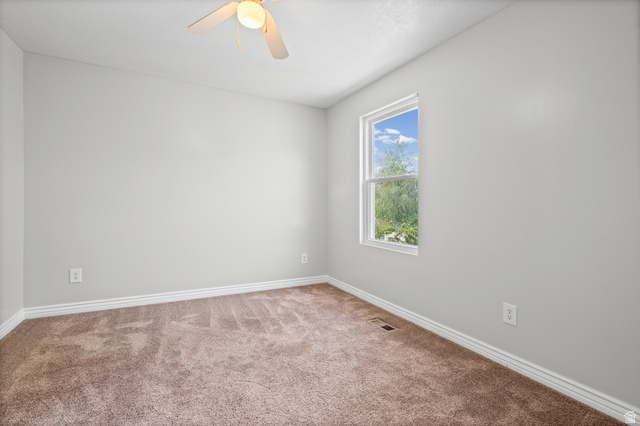 1346 Archmore Drive Springville, UT 84663 - Photo 19 of 32 Carpeted room featuring a ceiling fan with integrated lighting, a double-hung window, and neutral wall tones