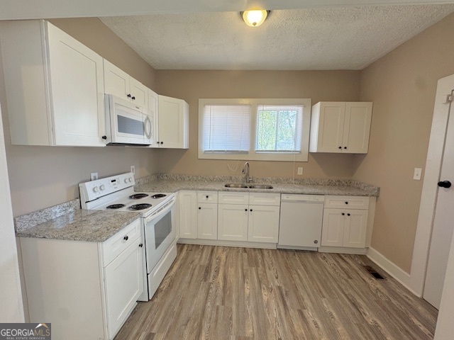 820 Peeples Street Southwest, Unit 820 Atlanta, GA 30310 - Photo 20 of 37 a kitchen with granite countertop white cabinets sink and stainless steel appliances