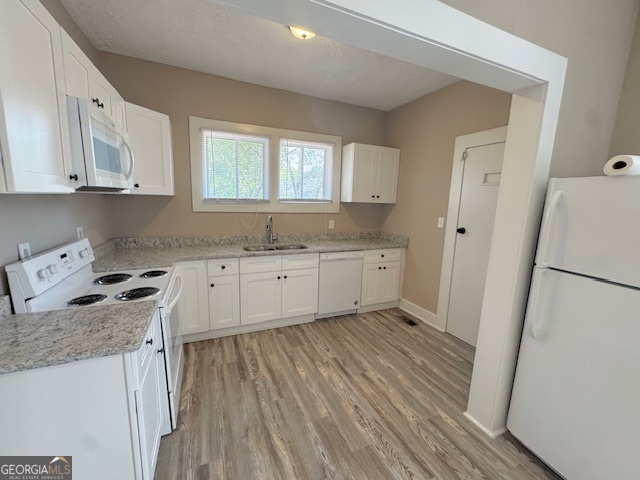 820 Peeples Street Southwest, Unit 820 Atlanta, GA 30310 - Photo 22 of 37 a kitchen with granite countertop white cabinets and white appliances